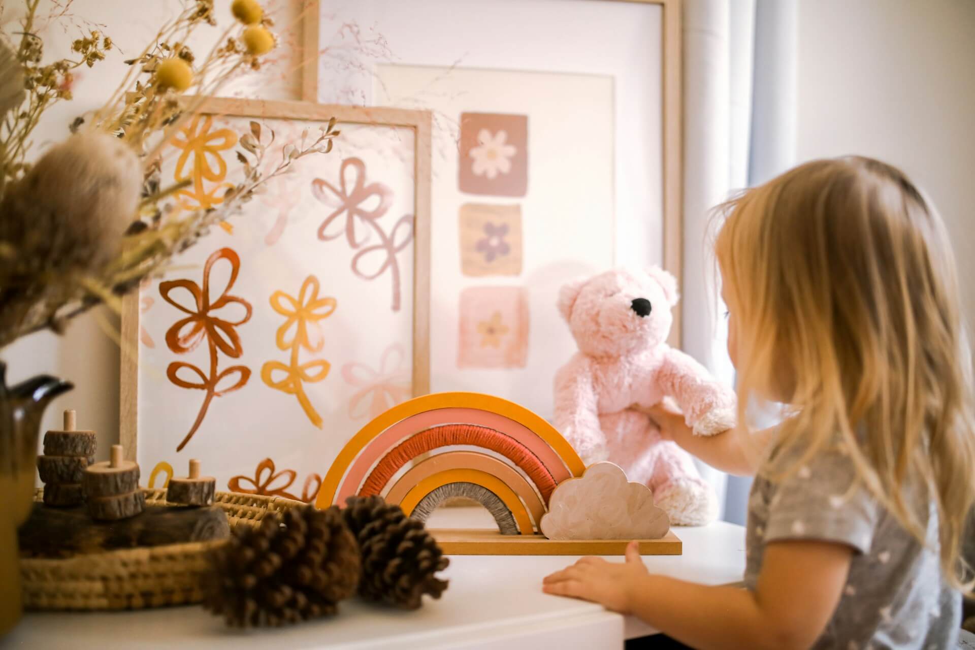 Child building a pretend-play scene with open-ended materials